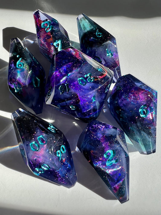 Cosmic styled resin polyhedral dice with coffin-shaped faces.